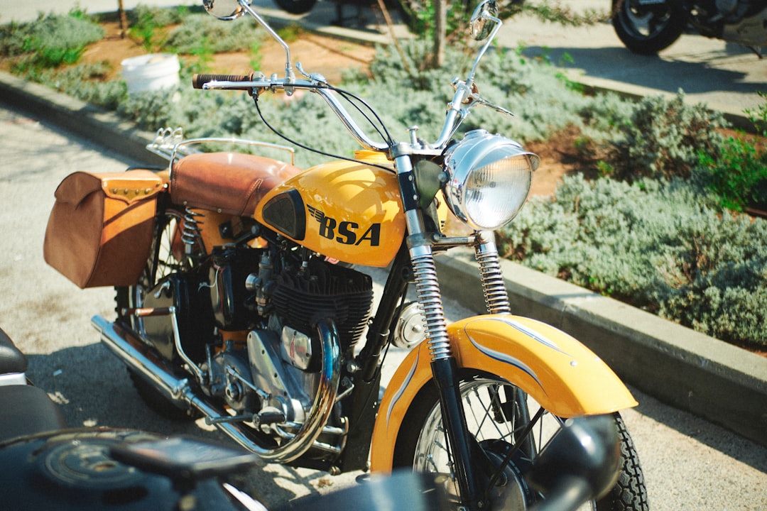 a-yellow-motorcycle-parked-on-the-side-of-the-road-pjvws0xjuec